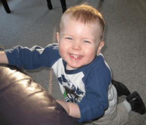 Kiddo plays next to the couch